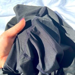 Black leggings with two strips on them.